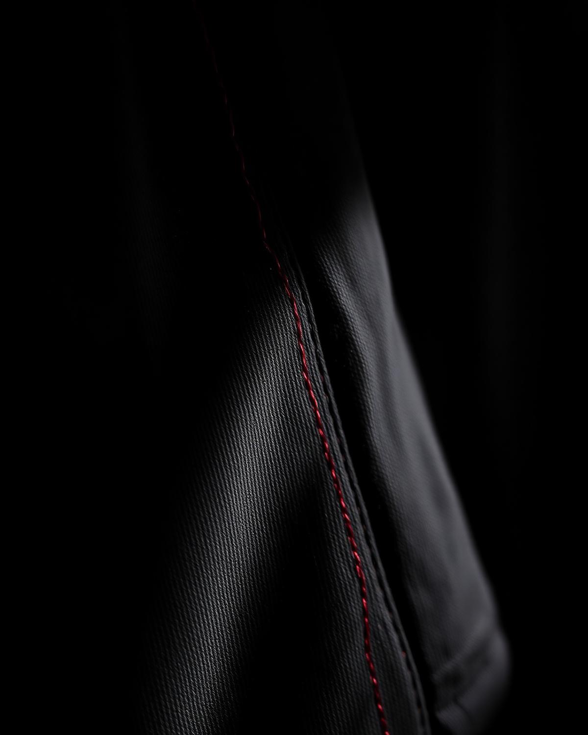Premium black garment with red stitch detail